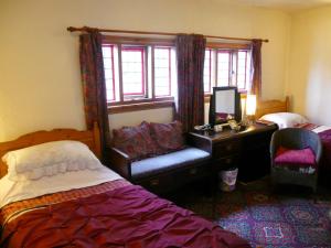 Tempat tidur dalam kamar di Hawthorn House Hotel
