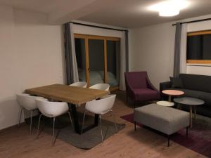 a living room with a table and chairs and a couch at Appartement am Berg in Ebene Reichenau
