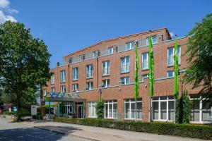 a large brick building with a clock on the front of it at ibis Styles Hamburg Alster City in Hamburg