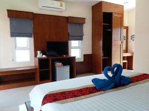 A bed or beds in a room at Tamarind Lanta Resort