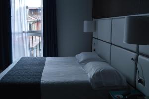 Postel nebo postele na pokoji v ubytování Hotel Sagittario