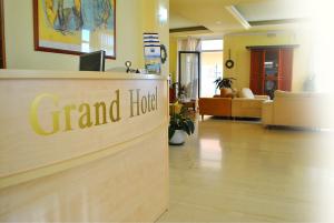 a grand hotel sign in a living room with a lobby at Grand Hotel Loutraki in Loutraki