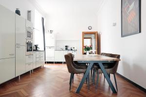 een keuken met een tafel en stoelen in een kamer bij Apartment KATZBACH - Cozy Family & Business Flair welcomes you - Rockchair Apartments in Berlijn