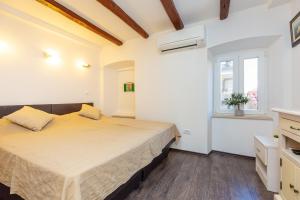 Posteľ alebo postele v izbe v ubytovaní City wall's studio apartment