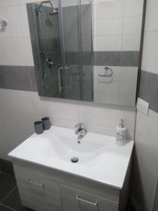 a bathroom with a sink and a mirror at bilocale Giomein in Breuil-Cervinia +3 photos