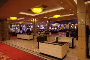 a casino lobby with a lot of tables and chairs at HOTEL FINIX CASINO in Kulata