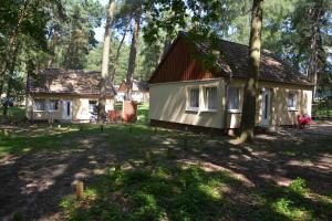 a house in the middle of a yard with trees at Ferienpark Retgendorf in Retgendorf