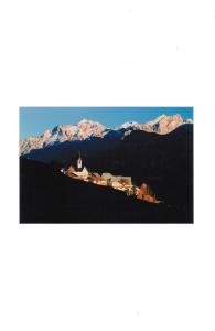 a small town on a hill with snow covered mountains at Tessanda Verdet in Guarda