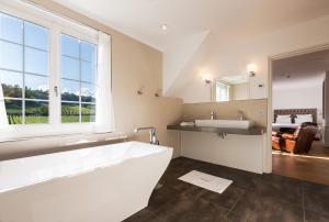 a bathroom with a large tub and a sink at le clos des belvals in Vertus +42 photos