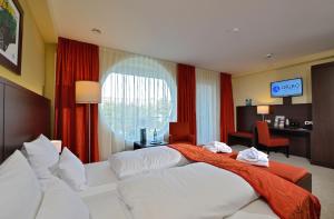 Postel nebo postele na pokoji v ubytování Aribo Hotel