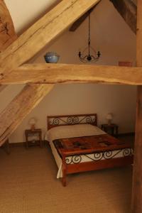 a bedroom with a bed in a attic at Le Clos de Châtres in Oisly