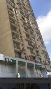 a tall building with a sign in front of it at سونستا العبور in Cairo