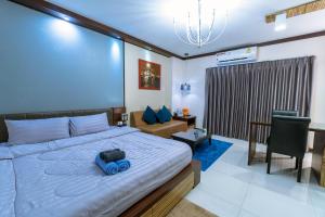 a bedroom with a bed with a blue bag on it at ARMO Nimman in Chiang Mai