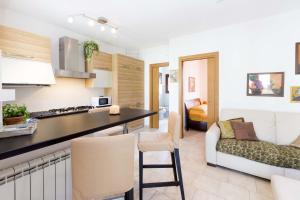 a kitchen and a living room with a couch at Bilocale Giulia in Casa Alzi