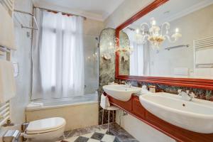 a bathroom with a sink and a toilet and a mirror at Hotel Antiche Figure in Venice