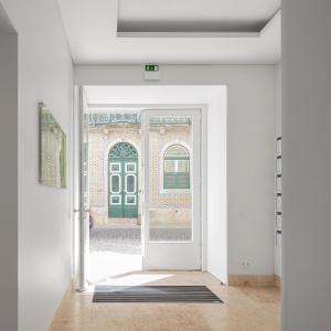 a room with a white door and a blue wall at Lisbon Serviced Apartments - Benformoso in Lisbon