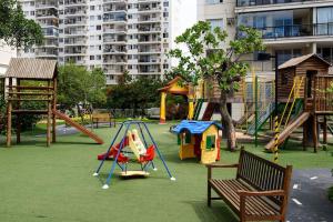 a playground with slides and play equipment in a park at Barra Family Resort - 3 Quartos in Rio de Janeiro