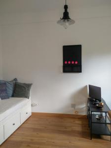 a bedroom with a bed and a tv on the wall at Casa da Tia Adozinda in Lisbon