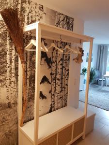 a display cabinet in a room with a wall at Hexen-Suite in Bad Harzburg +4 photos