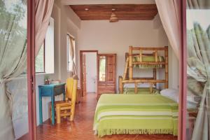 a bedroom with a bed and a bunk bed at Seaside Garden Ecolodge Mompiche in Mompiche