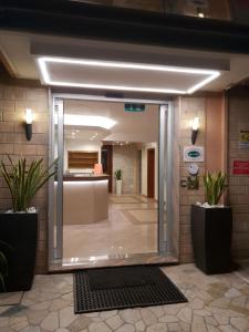 an entrance to a lobby with potted plants at Hotel Rado in Lido di Jesolo