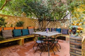 a patio with a table and chairs and a fence at Holiday Home Taormina 2 in Taormina