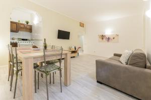 a kitchen and living room with a table and a couch at Holiday Home Taormina 2 in Taormina