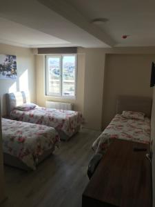 a room with two beds and a window at Gunes Hotel in Hacıbektaş