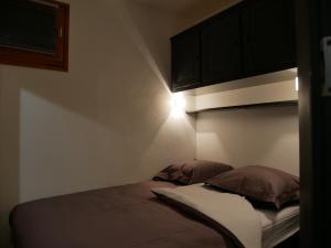 Appartement 4 personnes au pied des pistes du Linga à CHÂTEL في شاتيل: سرير عليه وسادتين في غرفة