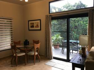 a living room with a table and chairs and a large window at Finca Caramelo in Boquete