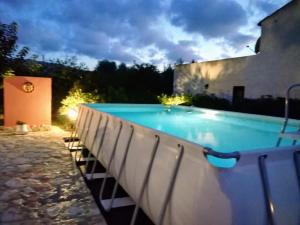 a large swimming pool in a backyard at night at Villa Nuccia Oasi di relax con piscina in Castellammare del Golfo