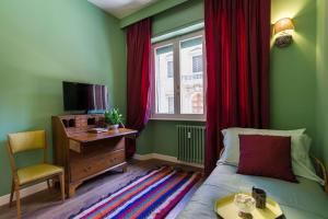 Televízia a/alebo spoločenská miestnosť v ubytovaní Frími Boutique Rooms b&b