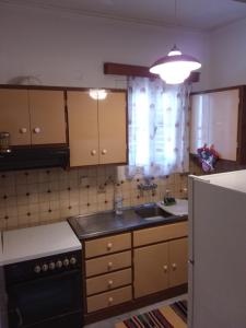 a kitchen with a sink and a stove top oven at Marios' Suite in Tinos