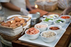 a table topped with bowls of food on a table at DeeProm Pattaya Hotel in Pattaya