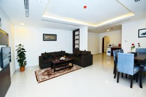 a living room with a couch and a table at Your Home Apartment Hotel in Dammam