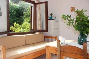 a living room with a couch and a window at Maria's Apartments in Kalyves