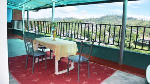 a table and chairs on a balcony with a view at Top View in Hatton