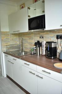 a kitchen counter with a sink and a microwave at Ambleside & Turtle beach towers in Ocho Rios