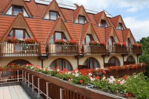 a building with flower boxes on the balconies at Ágnes Hotel in Hévíz