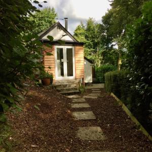 a small house with a stone path leading to it at Little Woodacott in Barnstaple