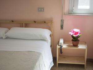 Posteľ alebo postele v izbe v ubytovaní Hotel Colombo