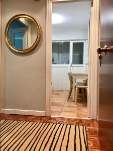 a hallway with a mirror on the wall and a table at Lauramer Apartamento Bakio in Bakio +11 photos