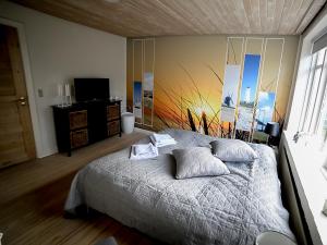 a bedroom with a bed with a painting on the wall at Sdr. Omme Bed & Breakfast in Sønder Omme