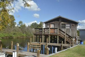 a house on a dock on the water at Camp Mack, A Guy Harvey Lodge in Lake Wales