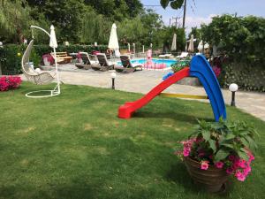 a red and blue water slide in a park at Villa Thassos Paradise in Limenas