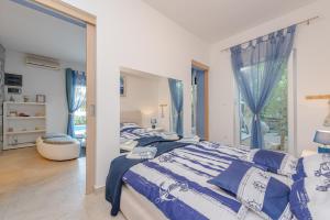 a bedroom with a bed and a large window at After All in Mandre +50 photos