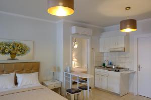 a bedroom with a bed and a small kitchen at Villa Thassos Paradise in Limenas