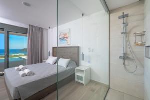 a bedroom with a shower and a bed with towels at Villa Gaia in Lindos