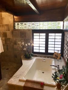 a large bathroom with a tub in a room at Hale Maluhia Country Inn in Kailua-Kona