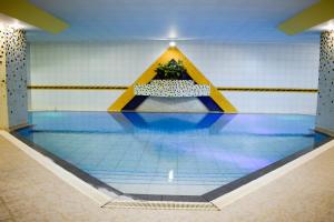 a swimming pool with a caution sign on the floor at Hotel Europa in La Paz